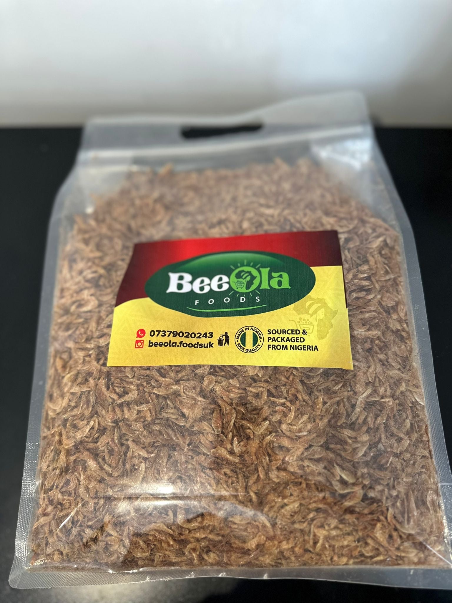 Packaged crayfish in a clear plastic bag with a label showing the brand 'Beeola Foods' and product name 'Blended Crayfish'.